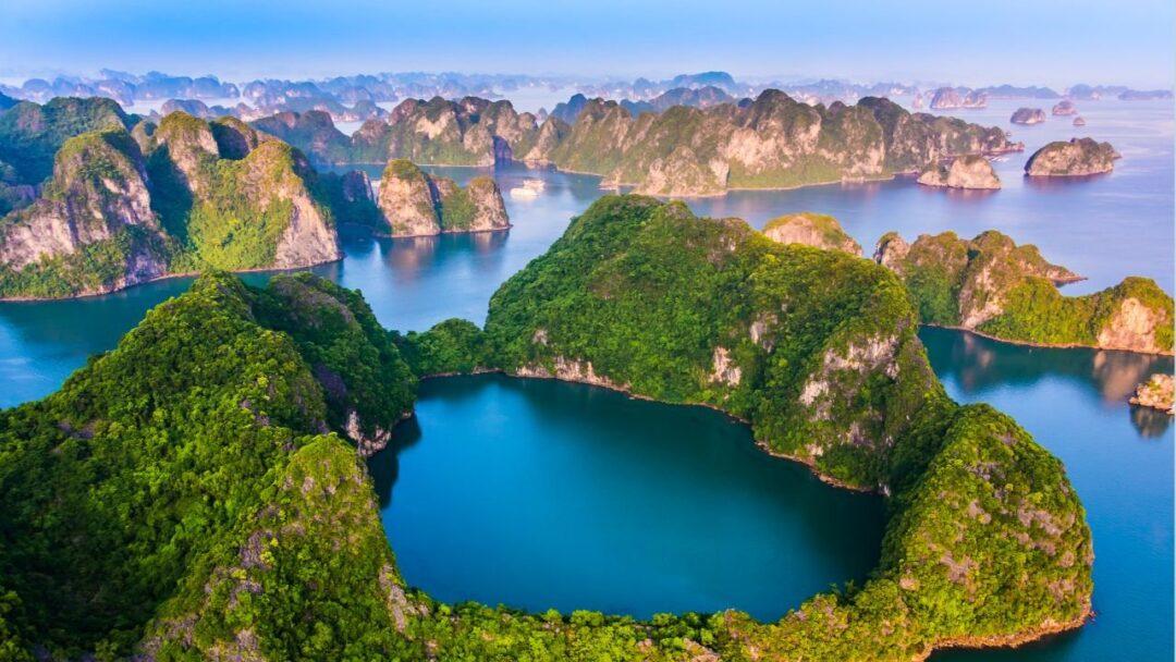 A breathtaking view of Ha Long Bay in Vietnam, with numerous limestone islands and islets jutting out of the turquoise waters.