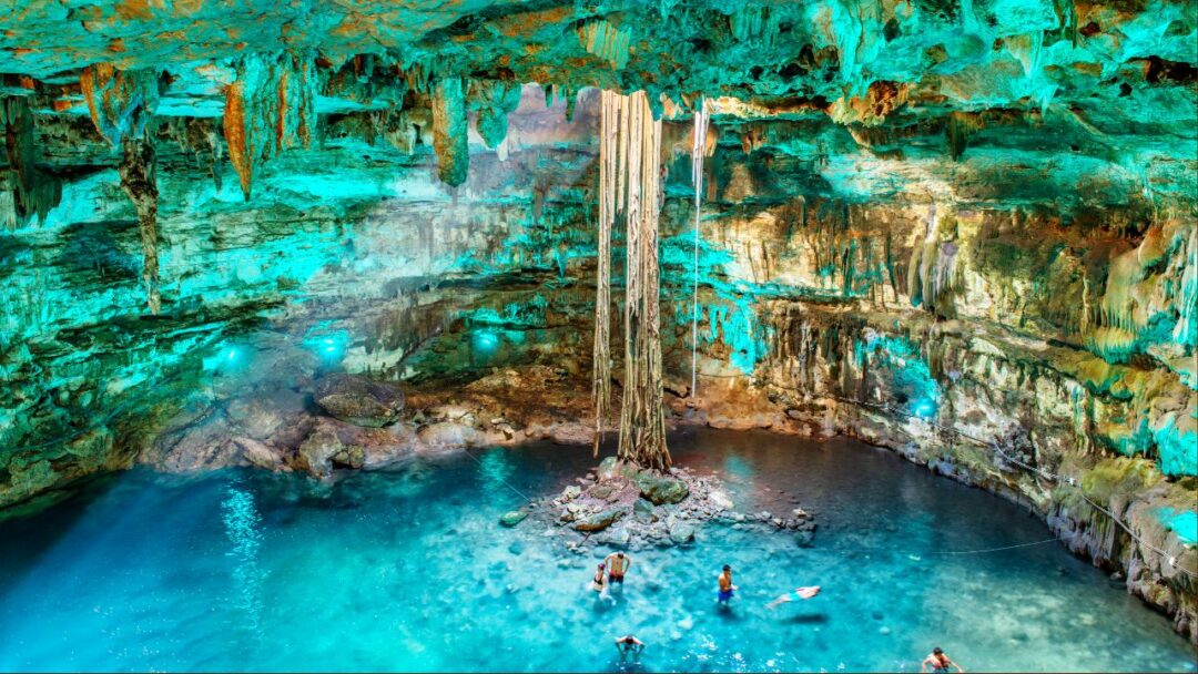 A scuba diver explores a captivating underwater cave, surrounded by stunning rock formations and shimmering blue water. Exploring the Enchanting World of Underwater Caves.Dive into the captivating realm of underwater caves, where adventure and wonder await.
