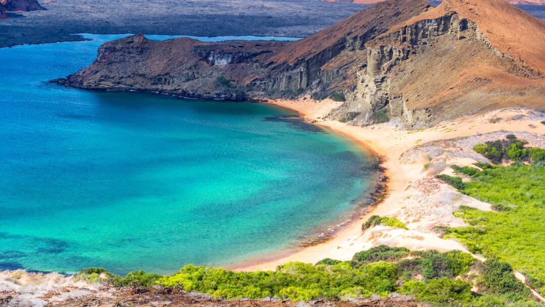 A breathtaking view of the Galapagos Islands, Ecuador, showcasing the pristine turquoise waters, volcanic landscapes, and lush vegetation. 10 Most Beautiful National Parks Around the World.