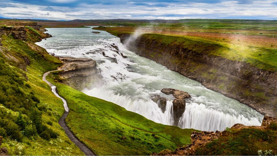 A stunning view of Gullfoss, Iceland's majestic waterfall cascading through rocky cliffs and creating a breathtaking natural spectacle. Top 10 Spectacular Waterfalls to Visit.