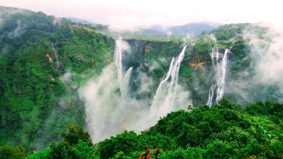 A stunning view of Jog Falls, India, showcasing the majestic waterfall cascading down rocky cliffs surrounded by lush greenery. Top 10 Spectacular Waterfalls to Visit.