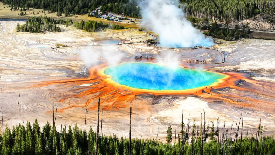 A breathtaking view of Yellowstone National Park, showcasing vibrant geothermal features and lush greenery. 10 Most Beautiful National Parks Around the World