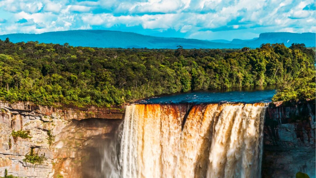 A breathtaking view of Kaieteur Falls, a powerful waterfall surrounded by lush greenery in Guyana. Top 10 Spectacular Waterfalls to Visit.